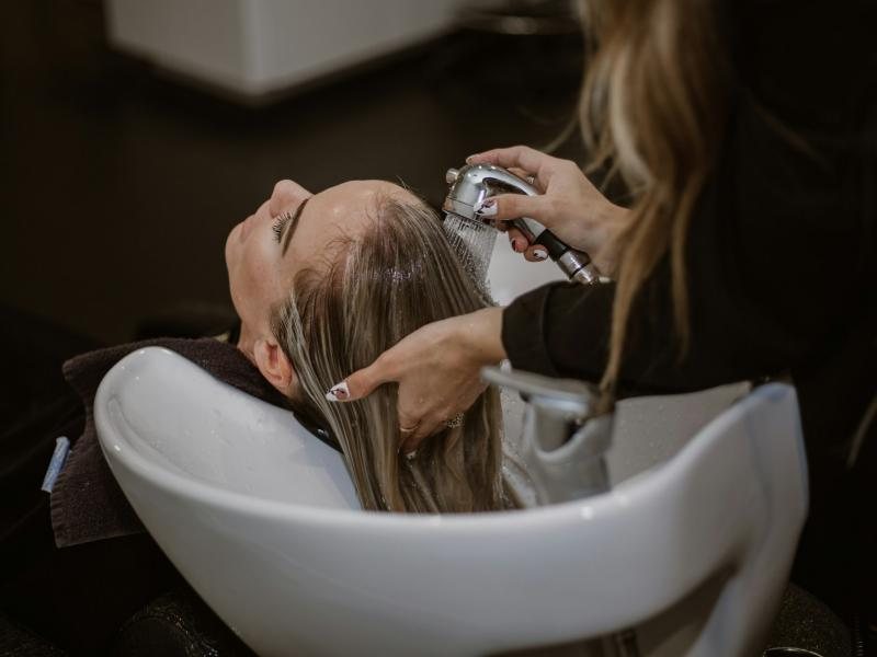 Hair being rinsed at a salon wash basin